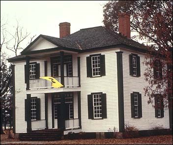 Two-story white colonial house.