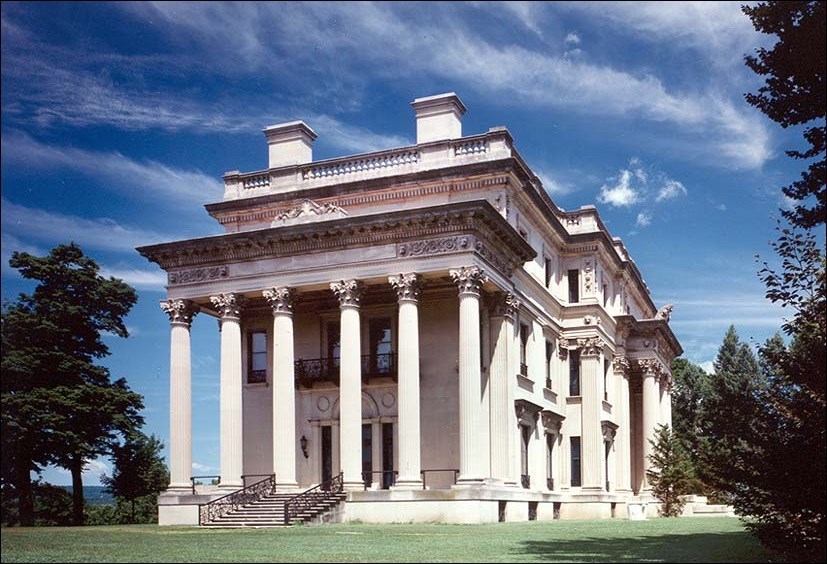 Photo of side exterior of stone mansion.