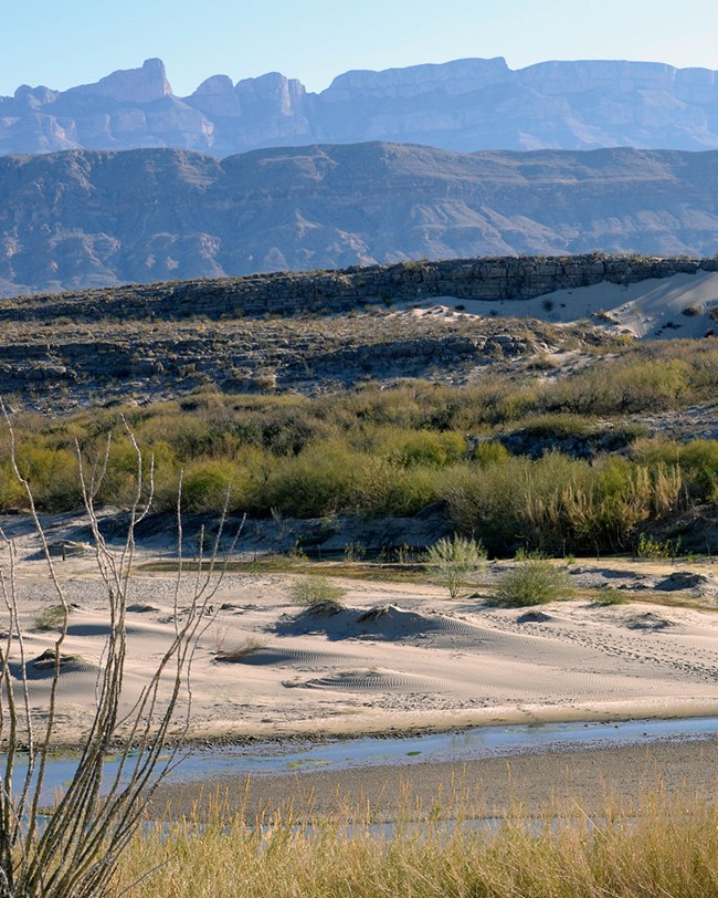 river, dunes, and mountains