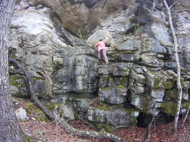 person climbing rock face