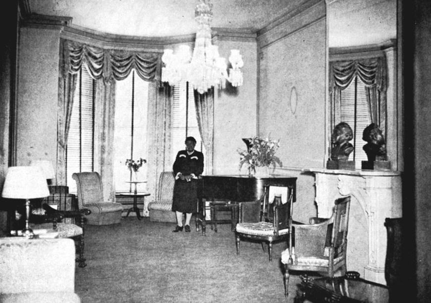 Bethune standing in the parlor.