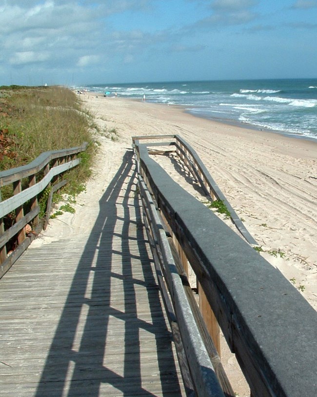 ramp to sandy beach and ocean waves
