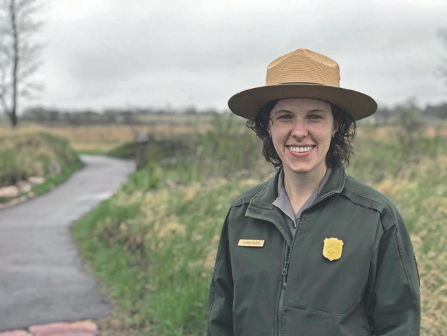Lauren Blacik in uniform standing on a trail