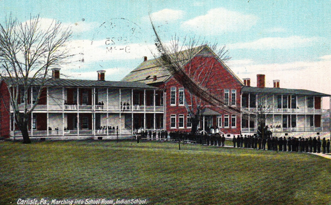 A large building with lines of people outside