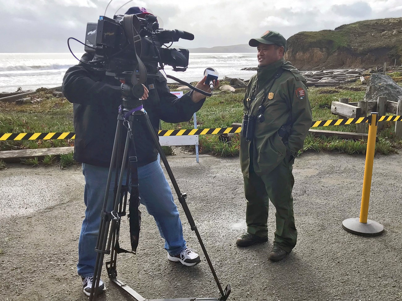 Uniformed park ranger faces a camera operator during an interview