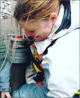 Close up of researcher pulling up sediment coring equipment