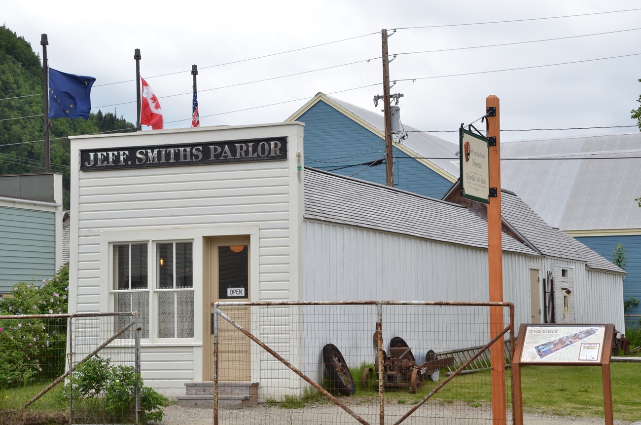 White building with sign "Jeff Smiths Parlor" written above.