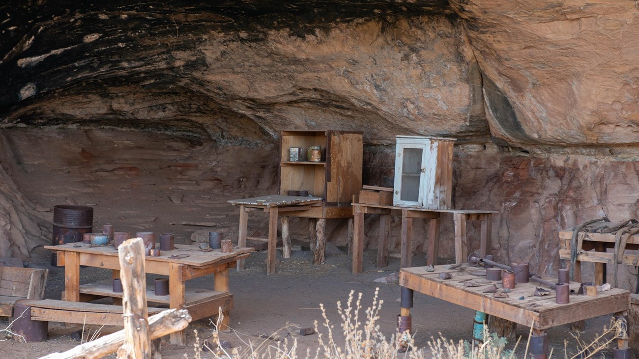 Photo of rustic tables in a rock alcove