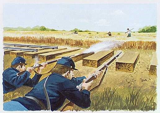 Soldier laying down with gun next to track