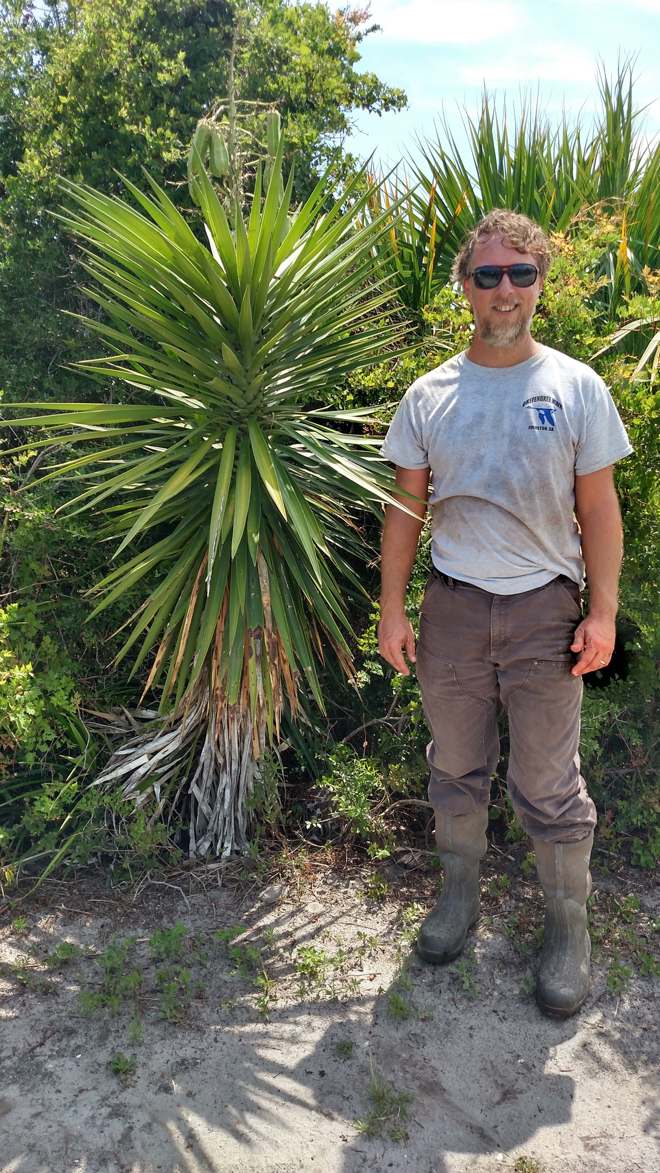 Forbes Boyle standing next to a yucca plant
