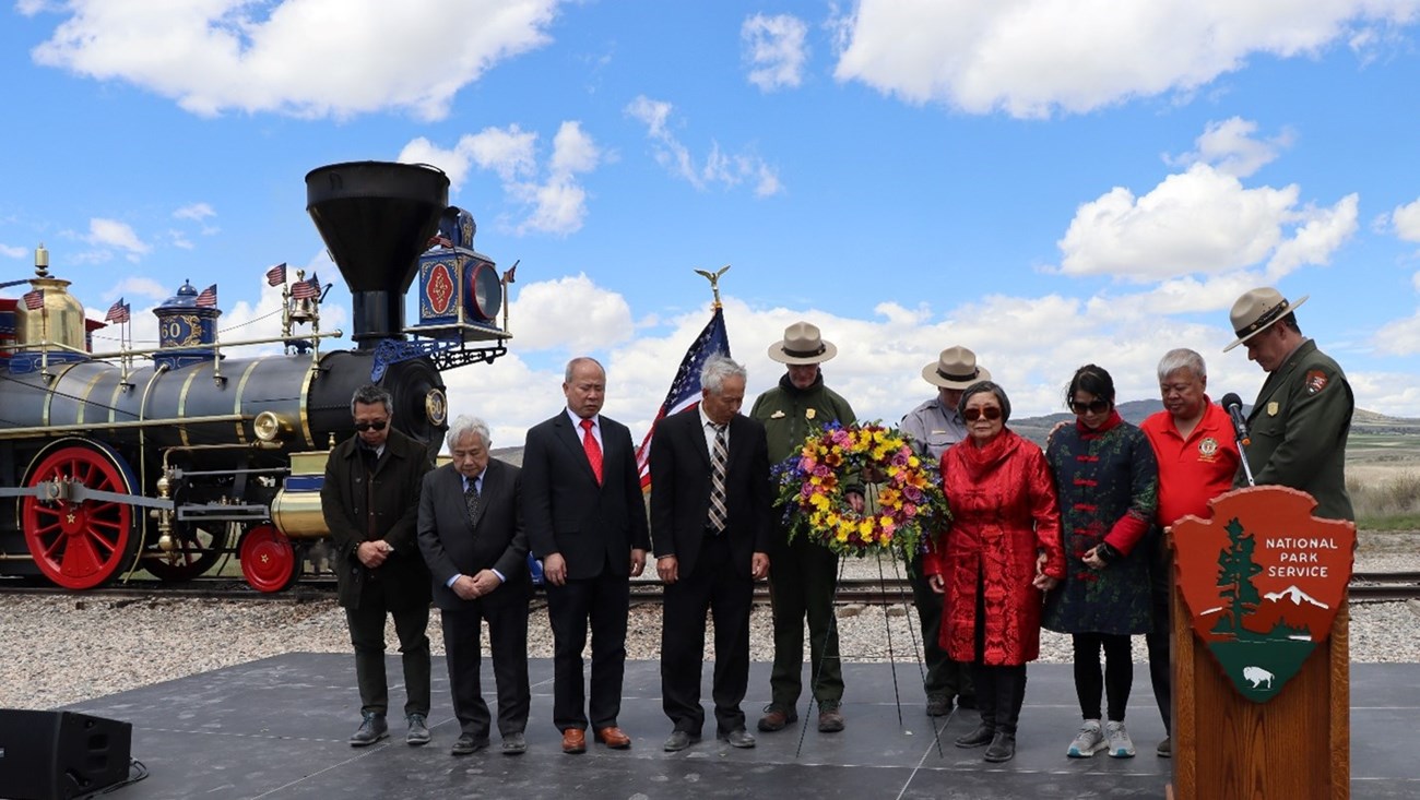 Several people stand together on a stage