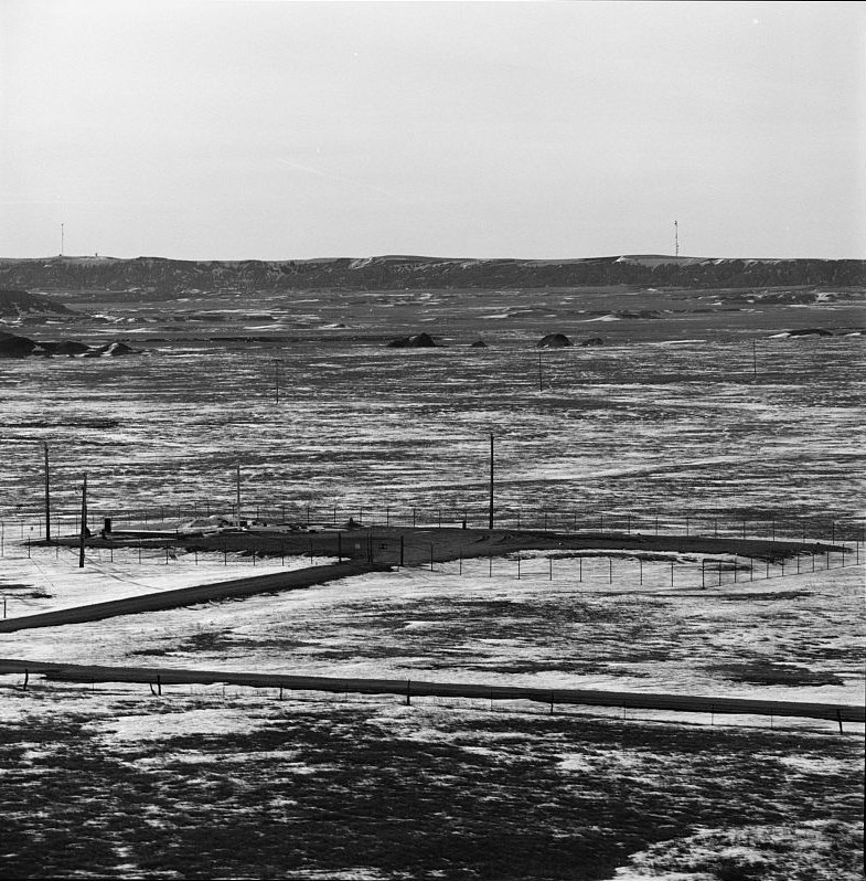 A fenced compound in a prairie landscape