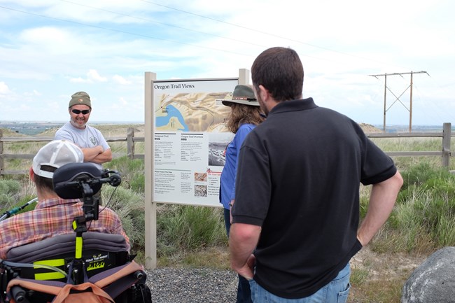 Visitors in front of Wayside Exhibit