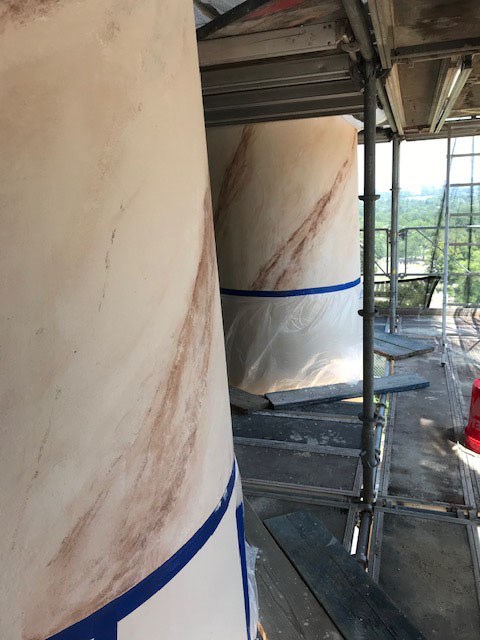 Scaffolding surrounds the columns of Arlington House during a rehabilitation of their faux-painting