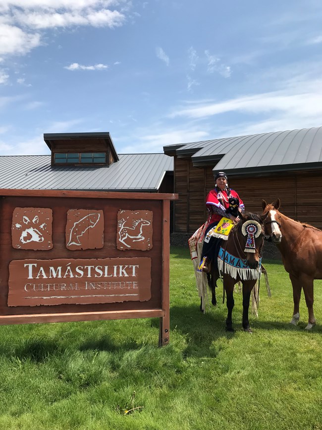 stuffed pup near two horses