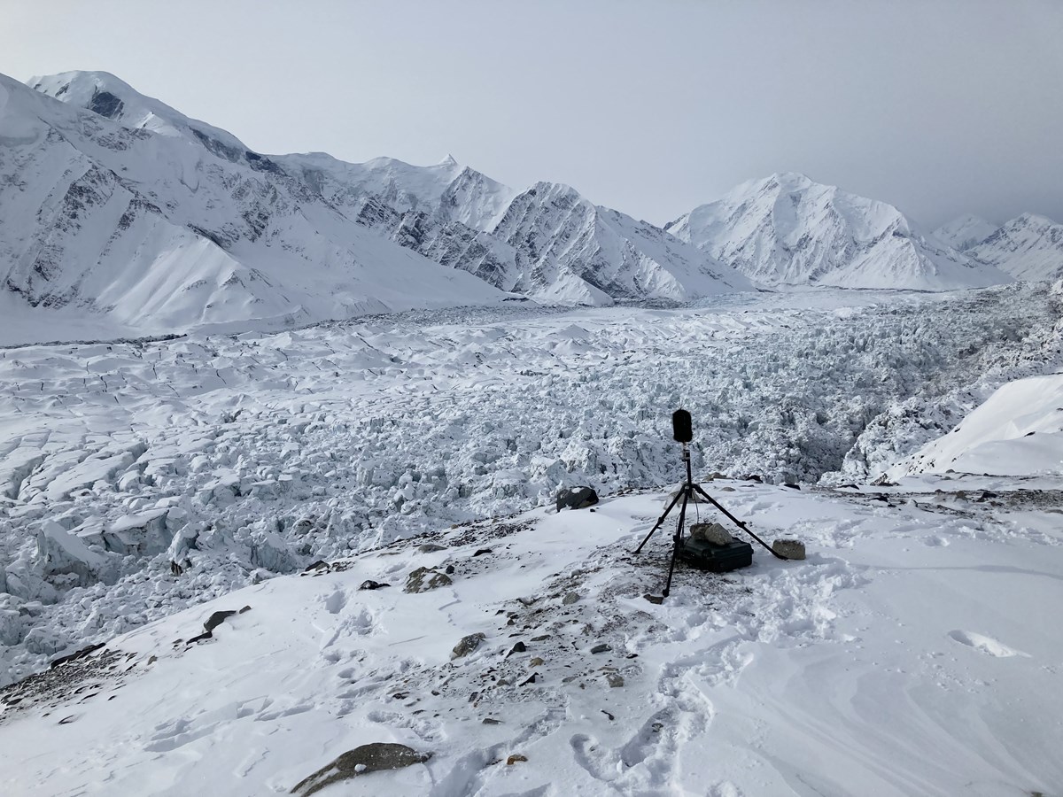 a microphone on a tripod perched on a snowy mountain