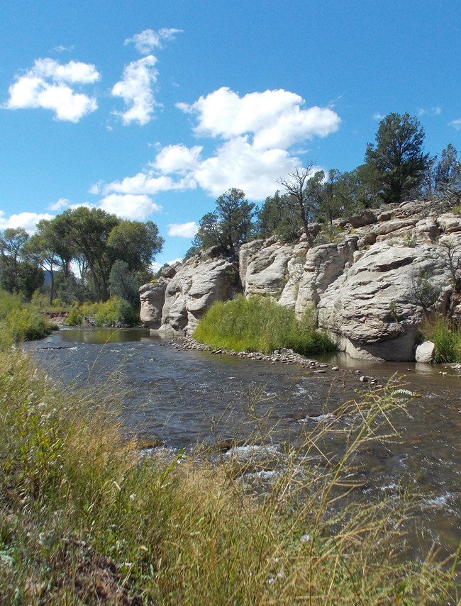 shallow river and bank with rock outcrop