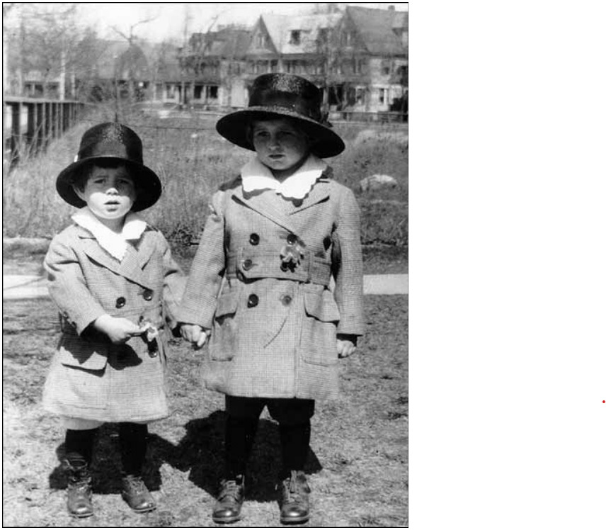 Two young boys standing outside in matching clothing
