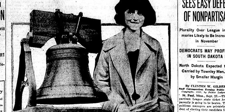 Detail, front page of newspaper showing young woman next to a large bell.