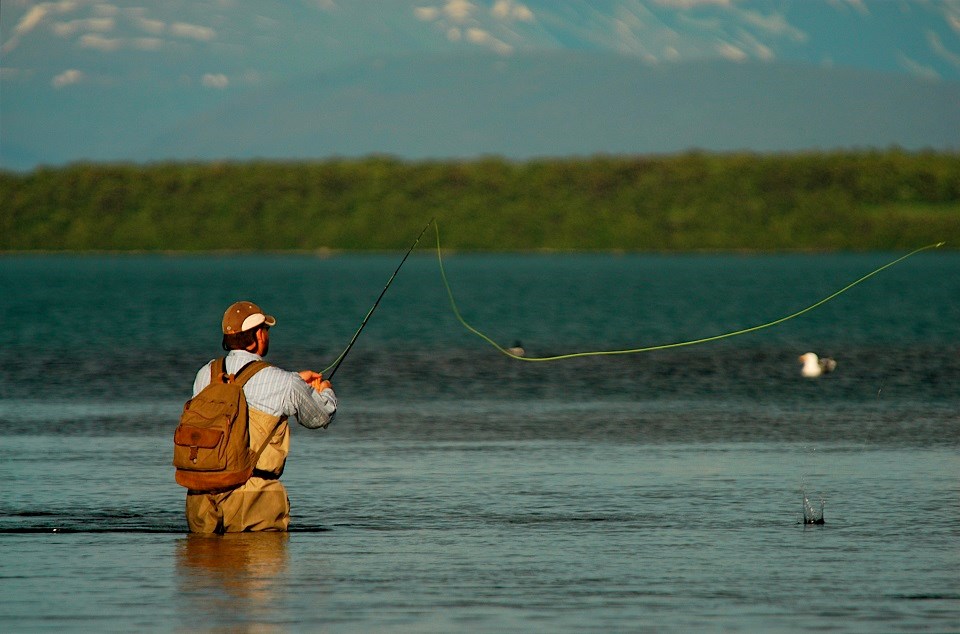 Fisherman fly fishing in a river