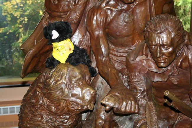 toy dog near a statue