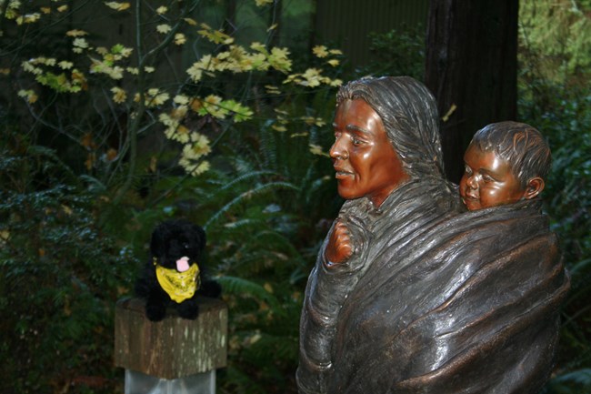 toy dog near statue of a Sacagawea