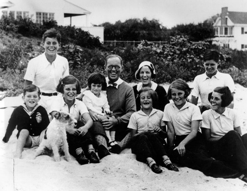 A family with eight children posing on a beach