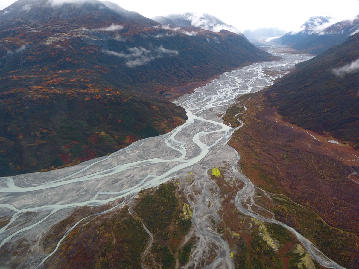 An aerial view of a braided river valley in autumn
