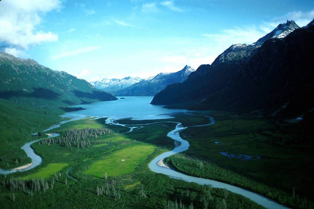 Rivers feed a turquoise lake.