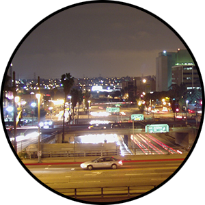 Cityscape featuring lights from cars, streetlights, and buildings.