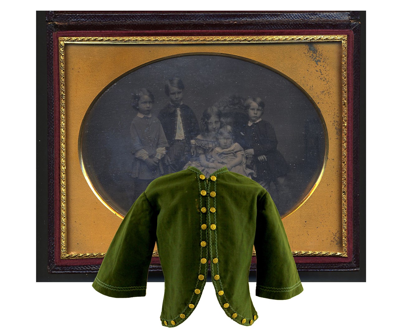 An image of a green wool jacket in front of a photograph of children, one child is wearing the jacket