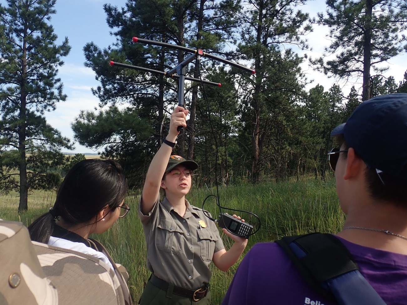 A park ranger demonstrates how to use a radio tracking unit.