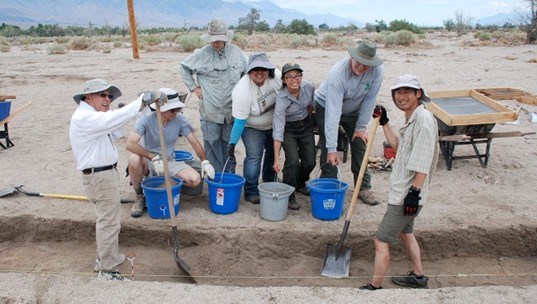 A group of people unbury a site