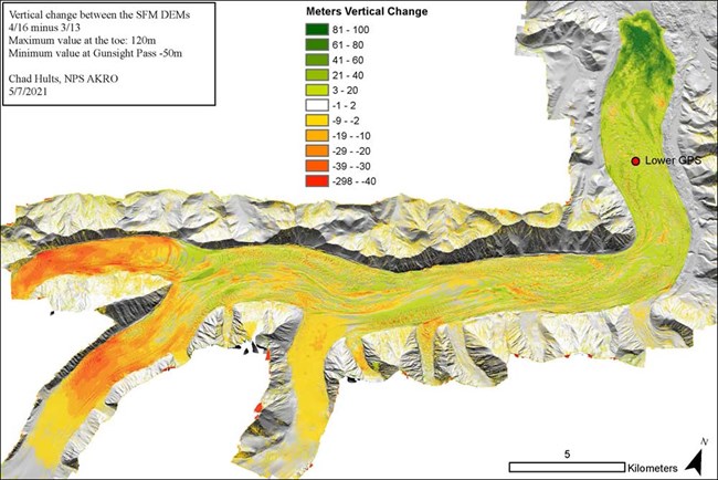 color scale overlaid on a satellite image of a glacier illustrating vertical change in the glacier, from upper portions to lower