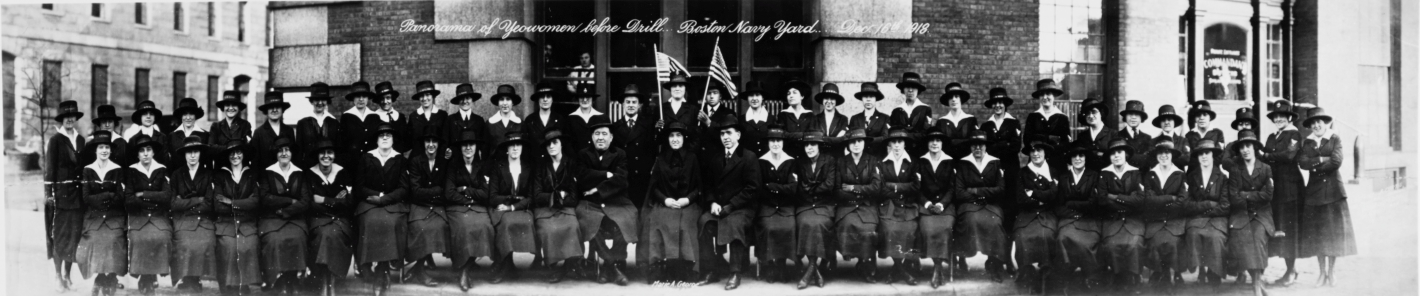 A large group of women in US Navy uniforms posing for a photo.