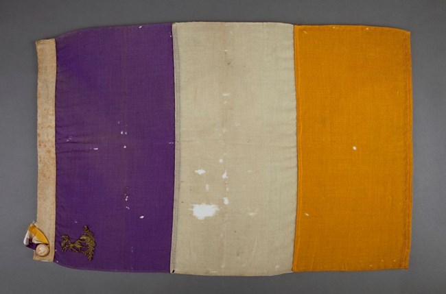 Purple white and gold flag of the NWP. National Museum of American History