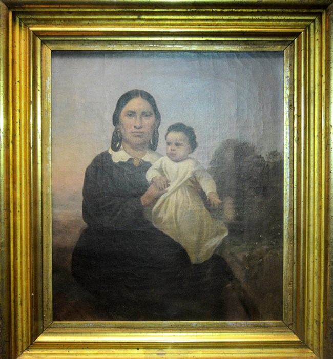 Woman seated holding baby on lap