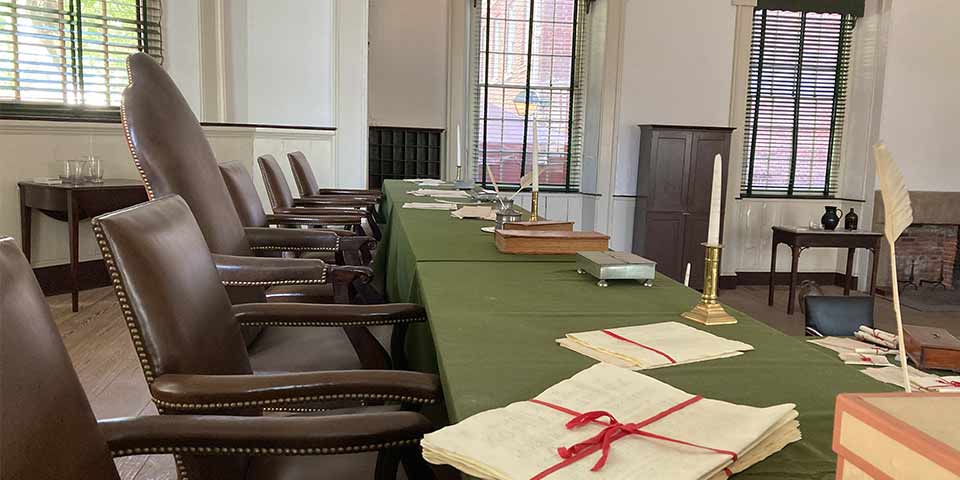 Interior view of courtroom showing judges bench on raised dais.