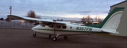 A small plane with a green stripe.