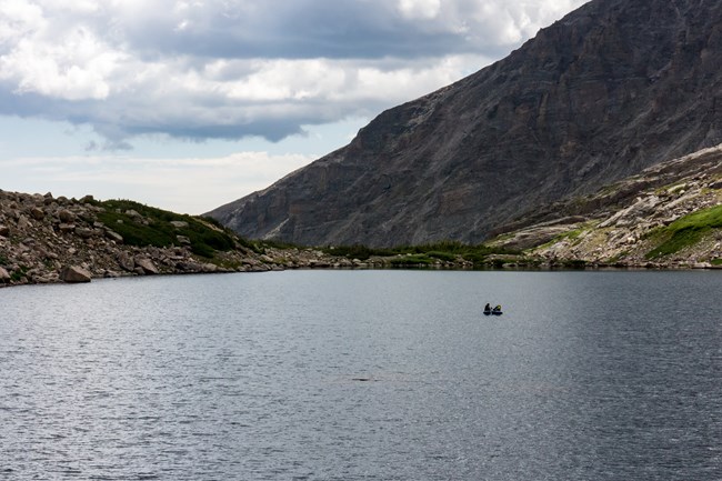 Small inflatable boat out in the middle of an alpine lake
