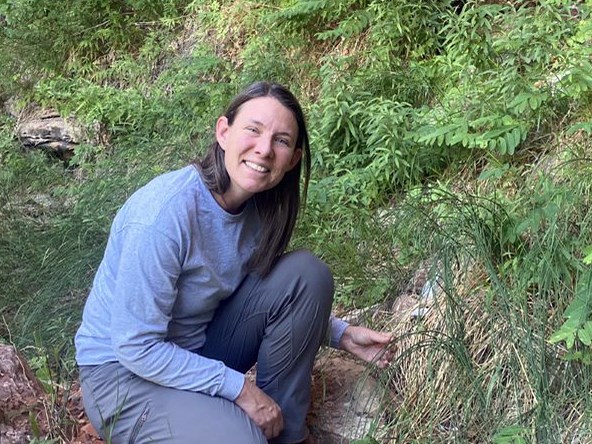 Woman crouched down and smiling at the camera
