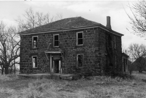 B&W photo of a two-story brick house.