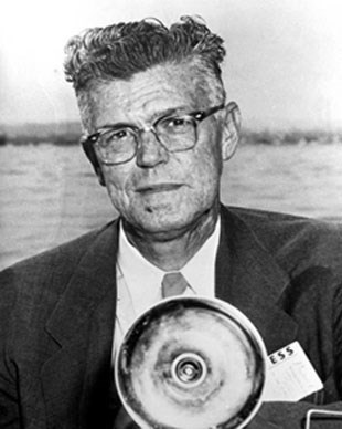 Man in a suit and tie holding a camera