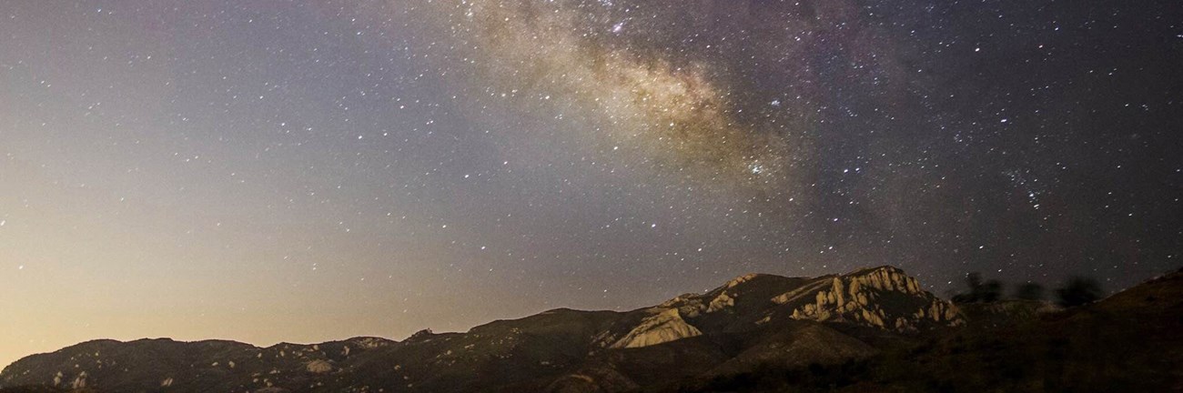 The Milky Way and light pollution over the mountains of Santa Monica Mountains National Recreation Area.