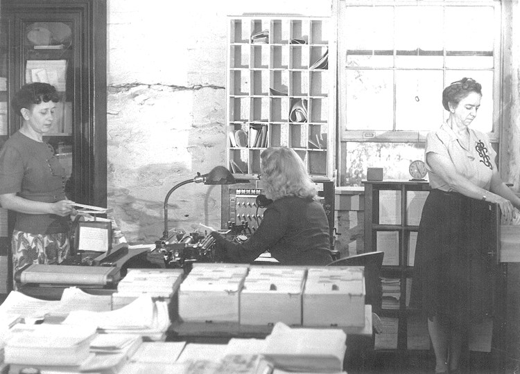 B&W image of women working in an office space