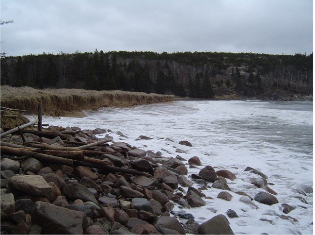 large waves crash over entire beach