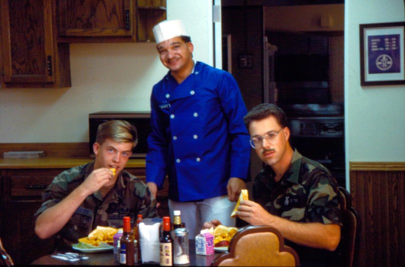 A military chef with two uniformed airmen