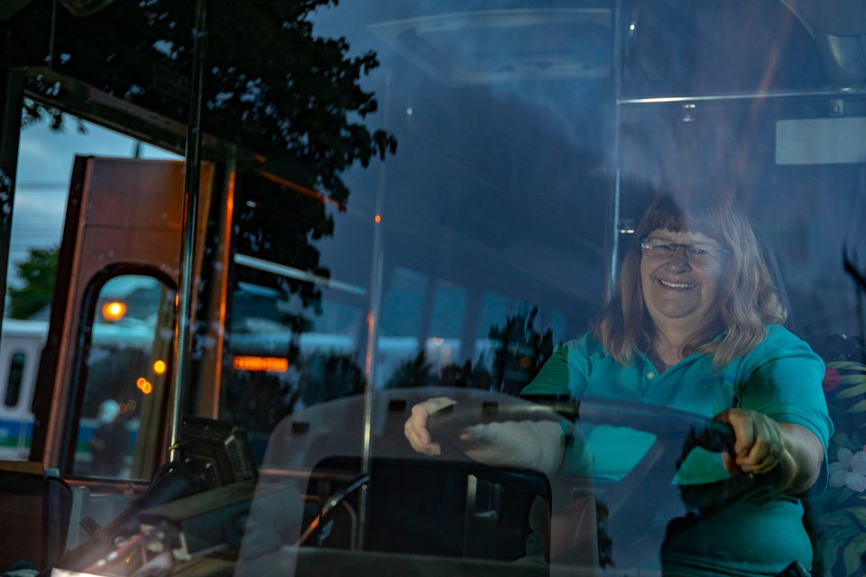 Bus driver smiles through windshield