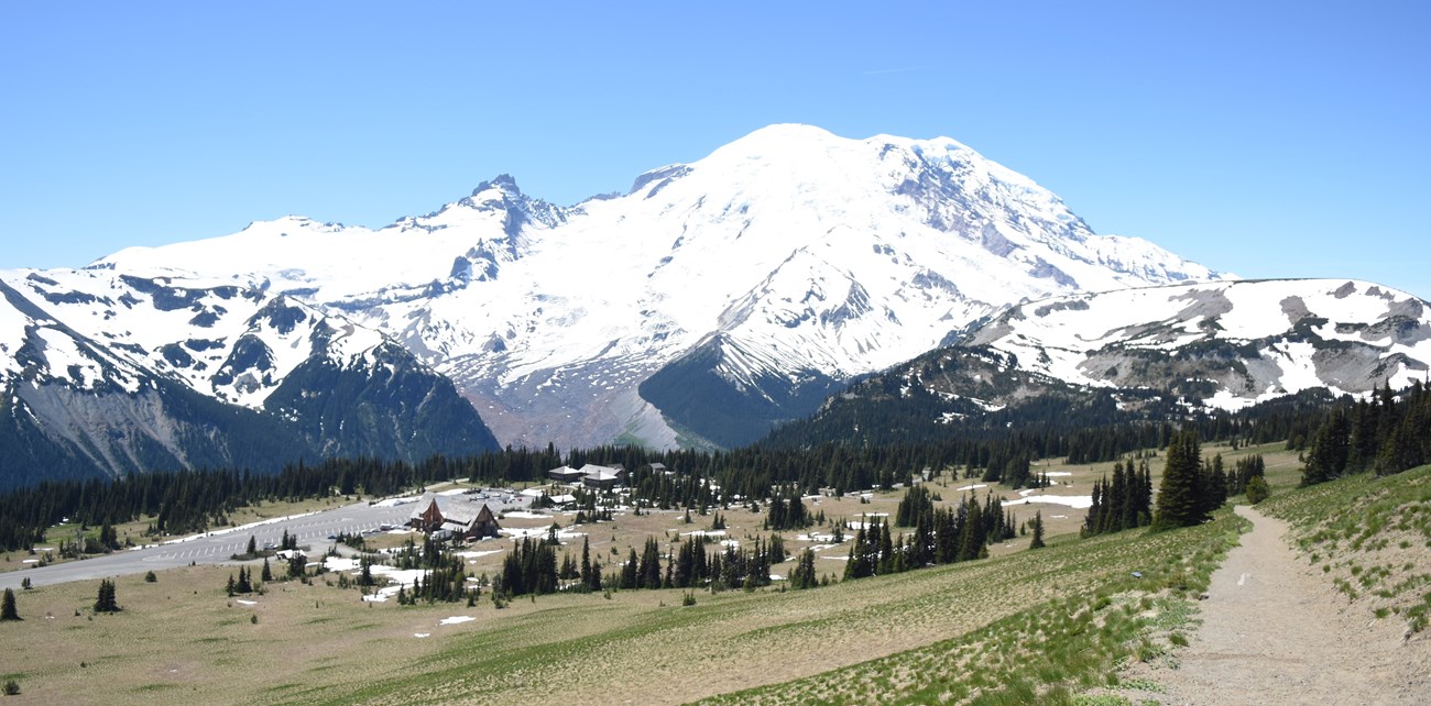 Buildings and road at Sunrise with Mount Rainier in background.