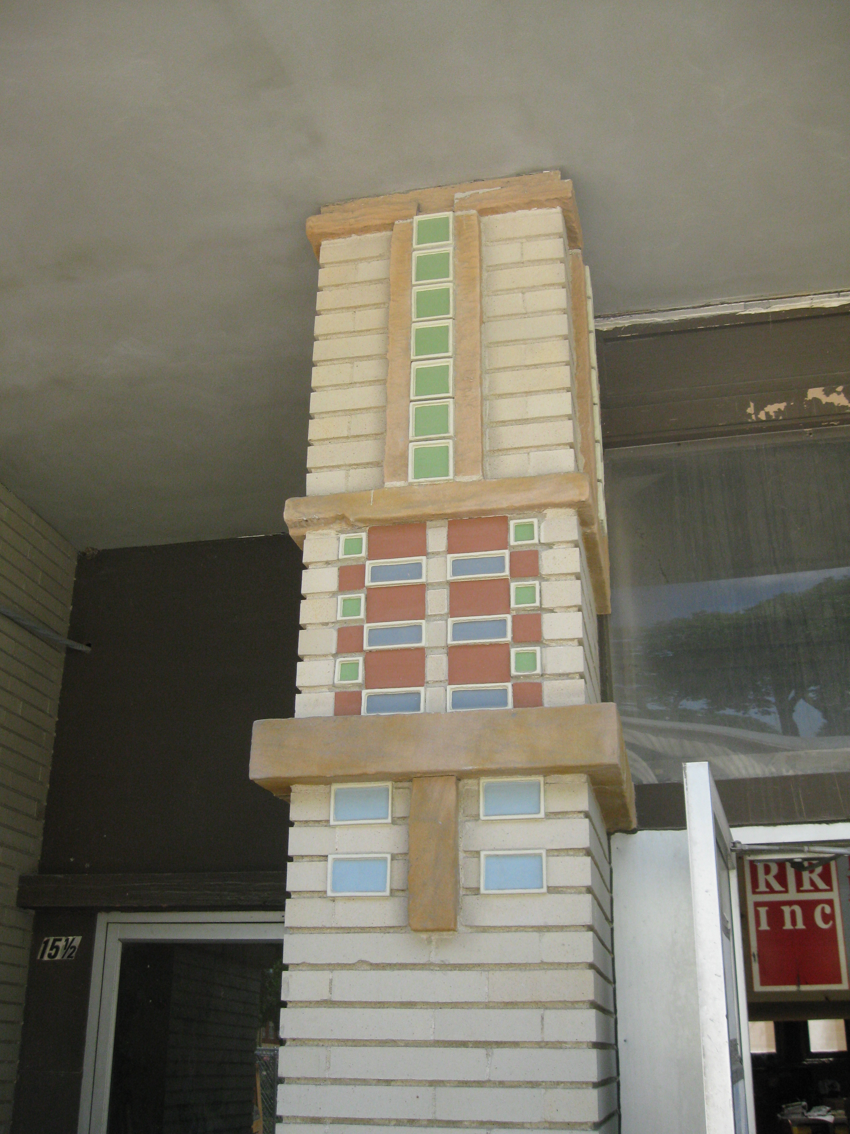 Green, red, and blue bricks on tan bricks.